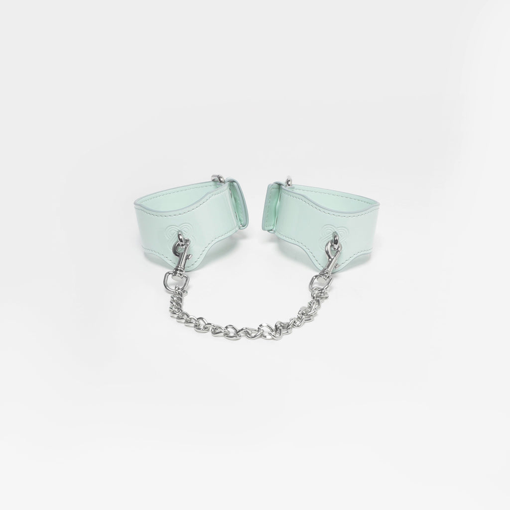 Smooth, hand-painted edge finishing on the structured mint green leather wrist frames