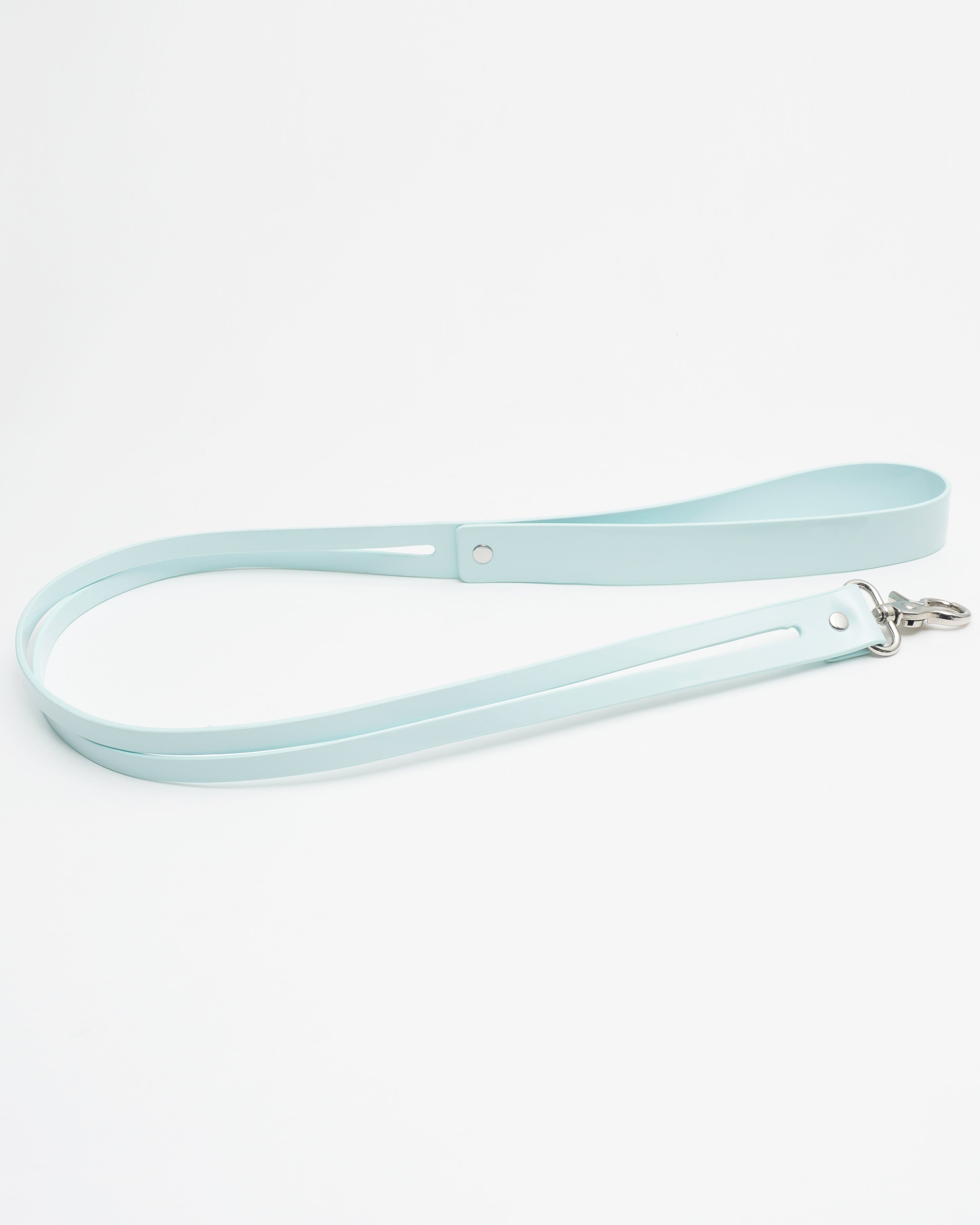Close-up of the oversized industrial spring-clasp on the Cyber Mint Kinetic Tether, showing the seamless connection to the collar.