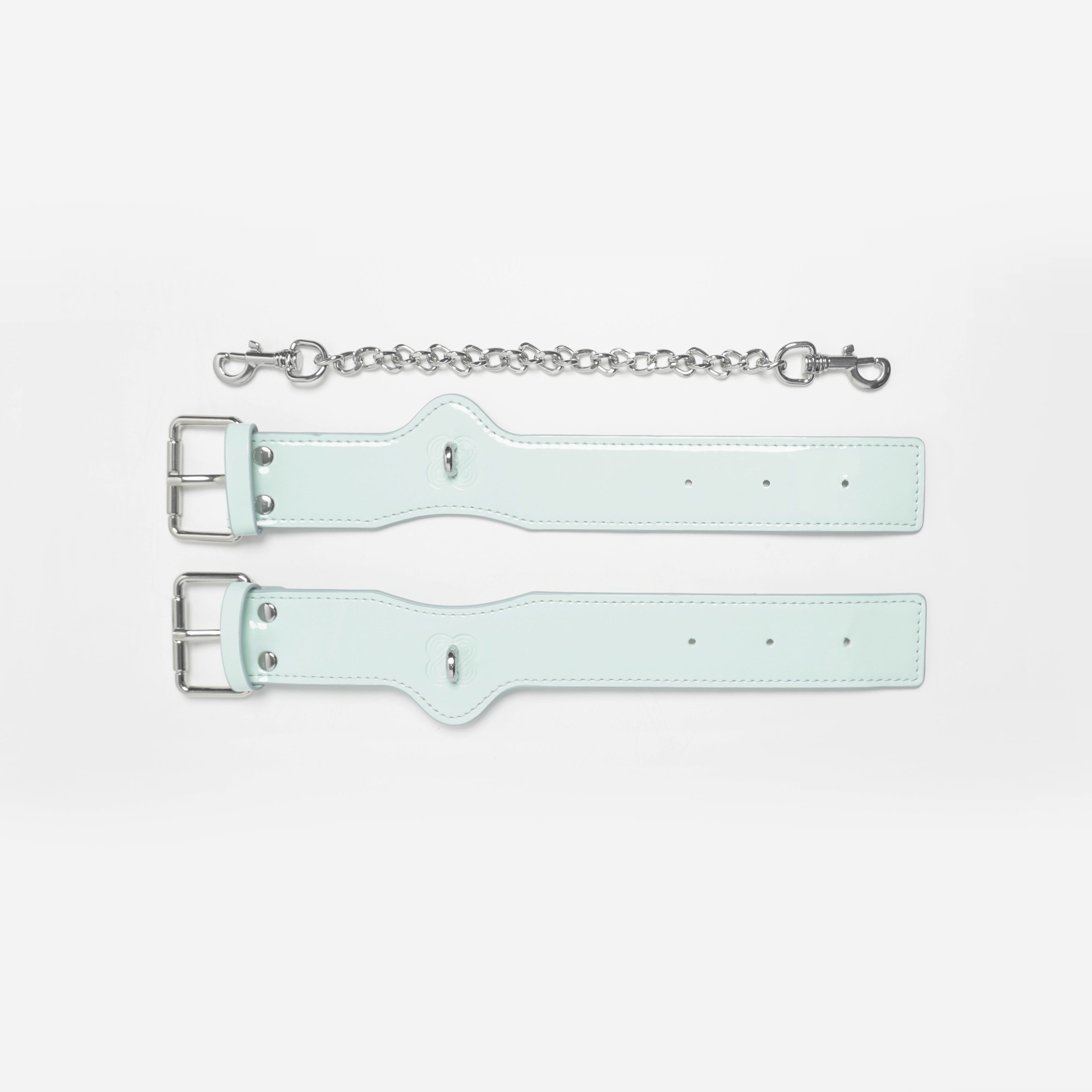 Cyber Mint patent leather wrist braces featuring signature Shibari-inspired embossing.