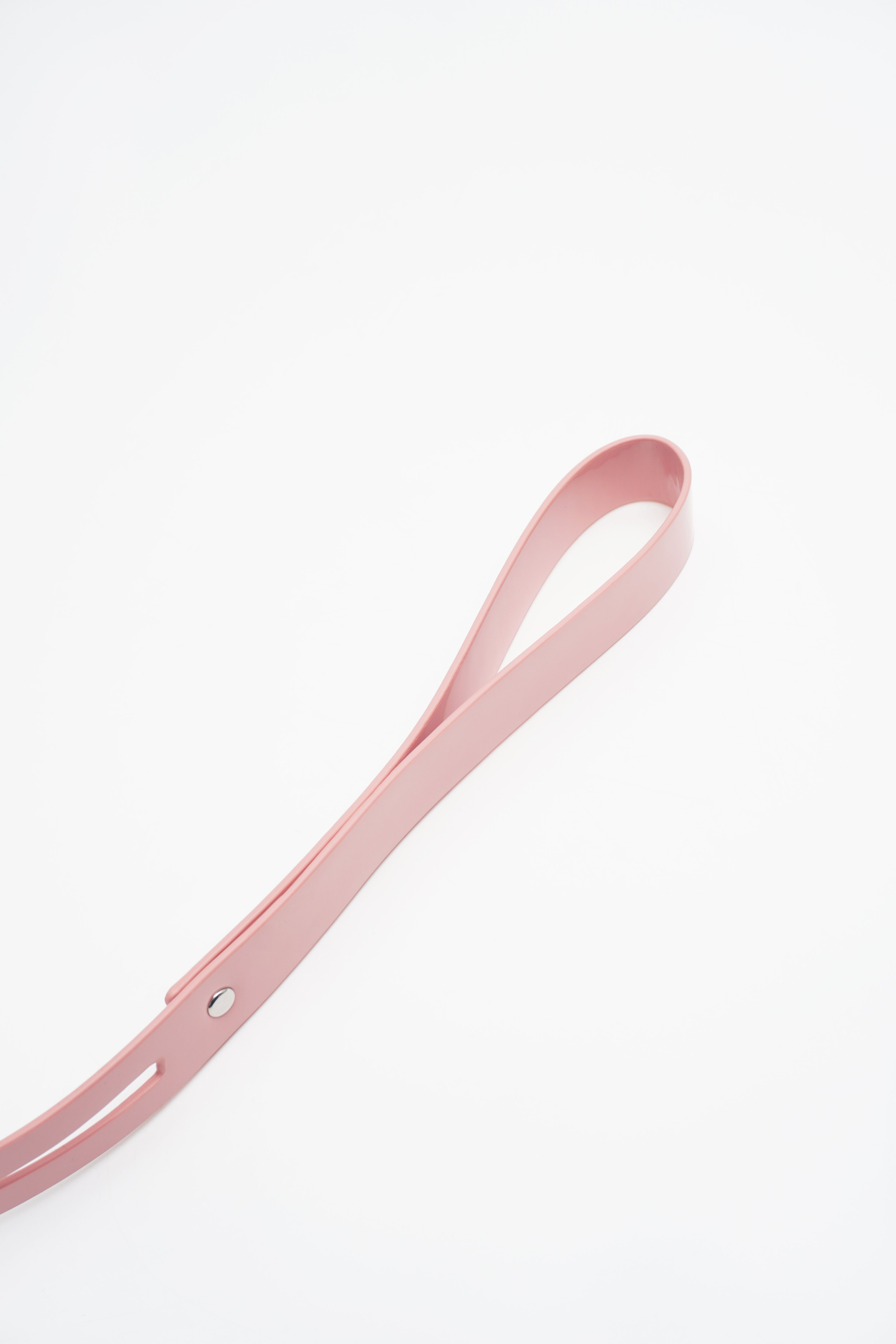 Adjustable buckle closure and reinforced stitching on a premium pink vegan leather collar.